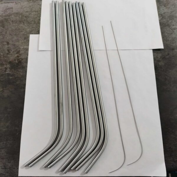 Precision-manufactured nitinol tube samples displayed in sterile packaging with measurement tools