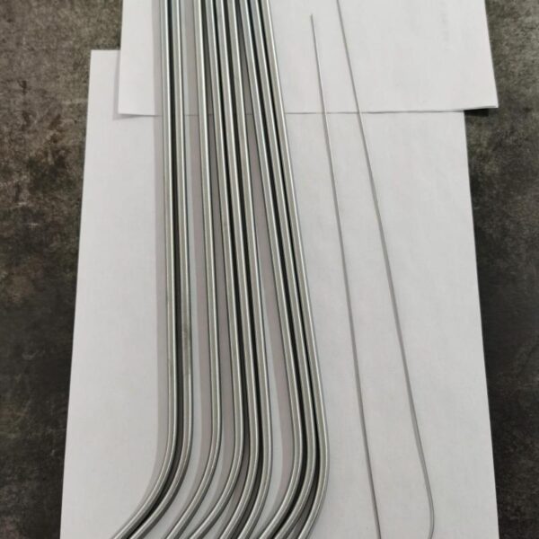 Precision-manufactured nitinol tube samples displayed in sterile packaging with measurement tools